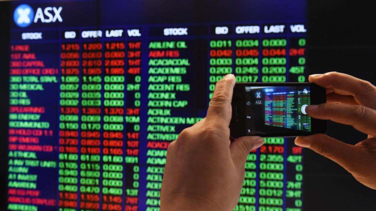 Australian shares flat at midday after oil price jumps