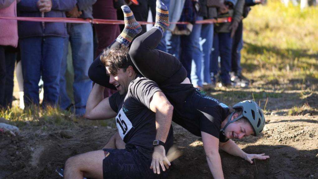 Competitors vie for beer in wife-carrying championship