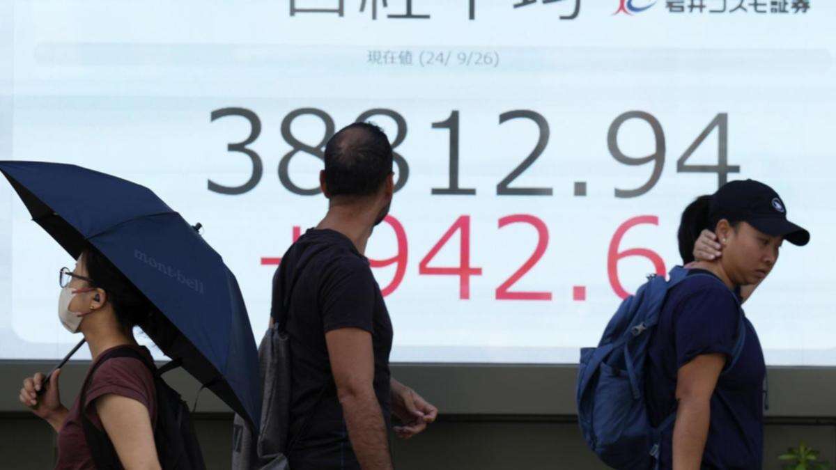 Most Asia shares holding, Japan rate fears dent Nikkei