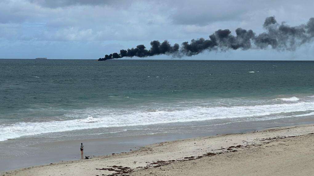 breakingBoat on fire off Cottesloe, two men aboard in rescue dinghy