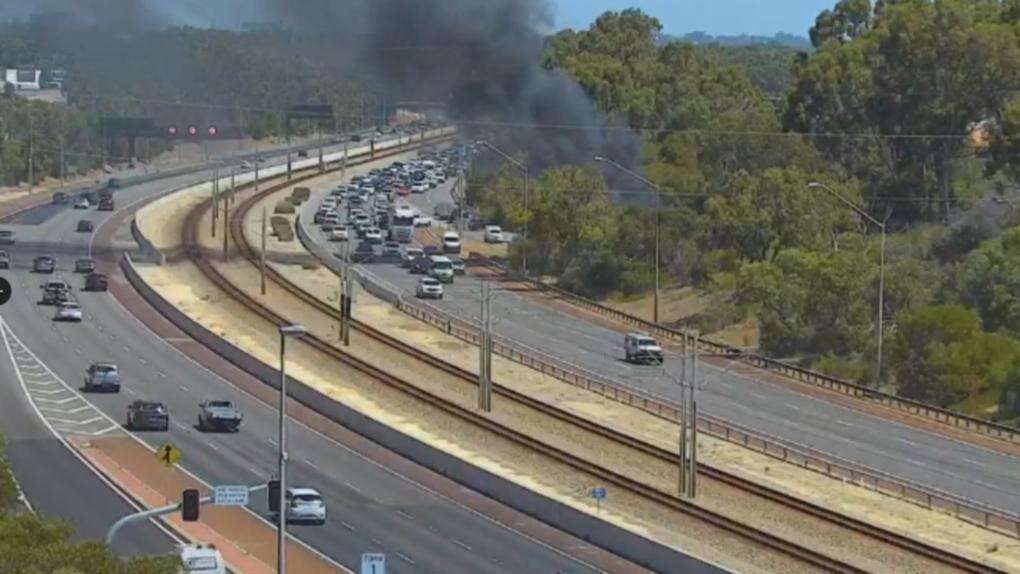 breakingTraffic chaos on busy Perth freeway after van catches fire