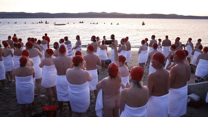 Swimmers strip down and the ocean during winter solstice