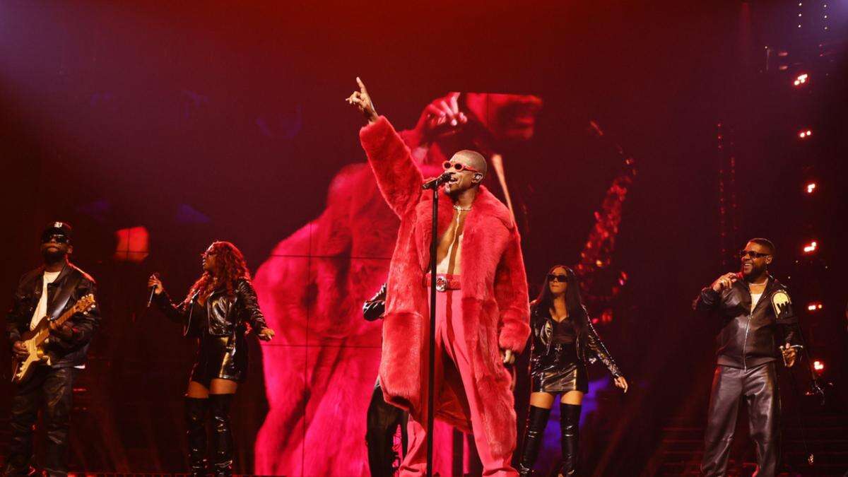 Usher returns to the stage after neck injury