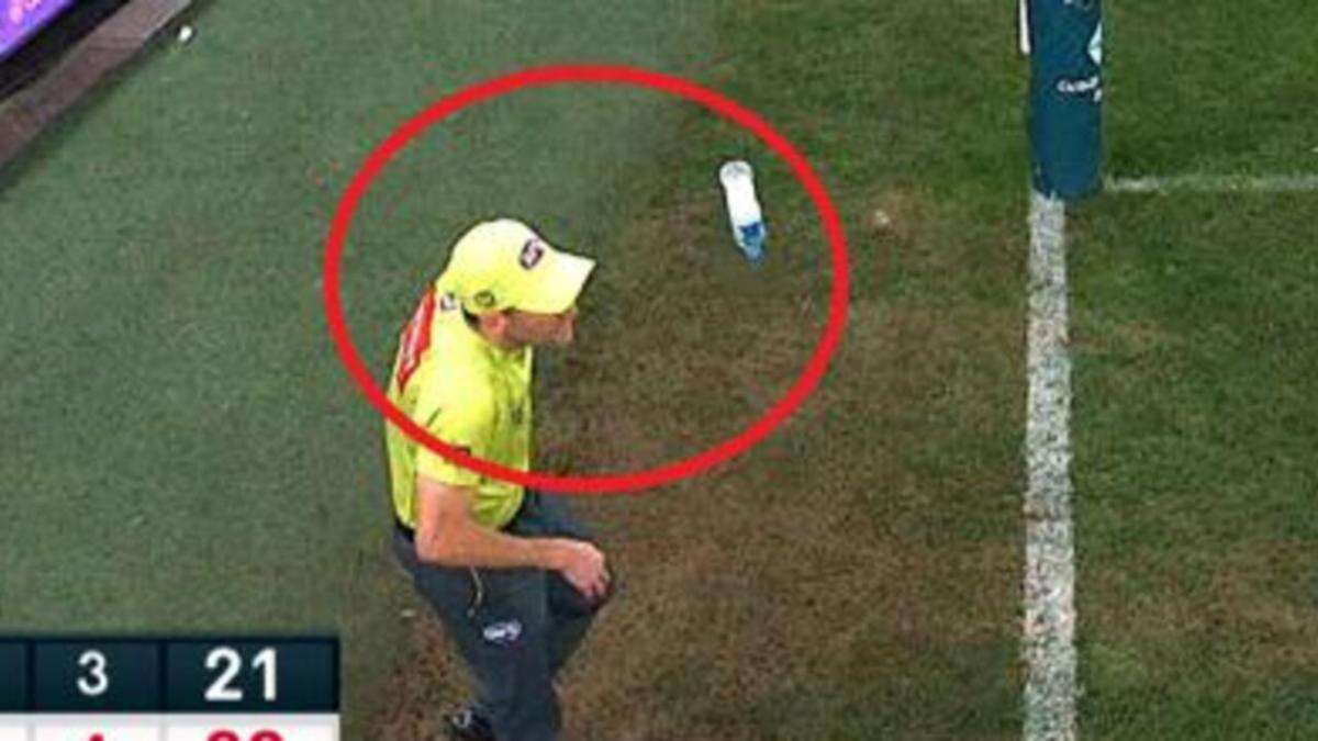 Man charged after umpire hit with bottle