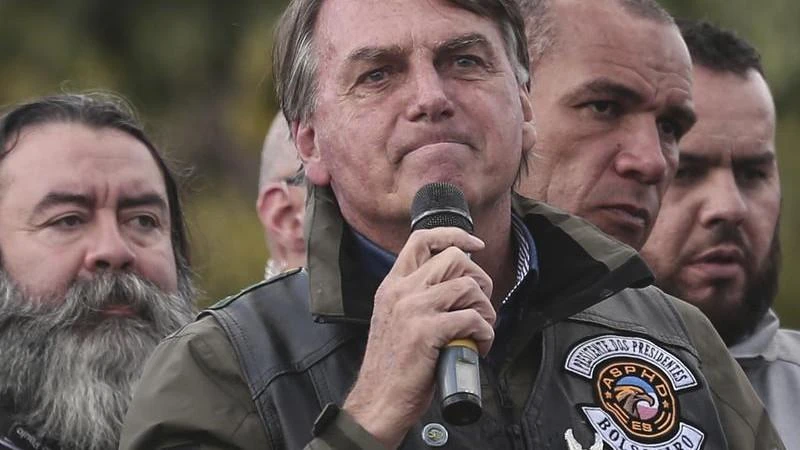 Maskless Brazilian president fined