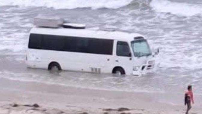 Bizarre sight of bogged bus at beach