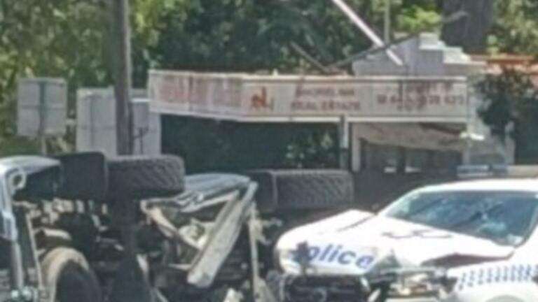 Car flipped in crash with police car