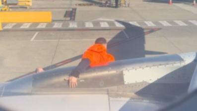 breakingJetstar passenger in custody after emergency exit door drama