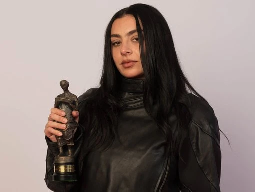 Charli xcx quips 'I am hardly Bob Dylan' as she's crowned Songwriter of the Year at The Ivor Novello Awards