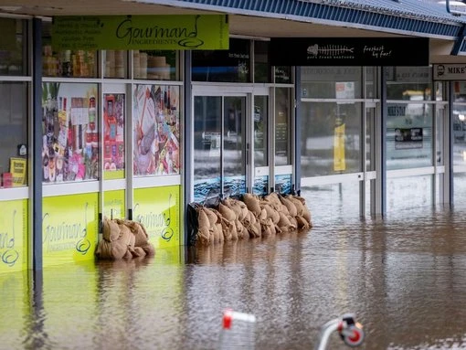 Floods submerge town centres and isolate communities
