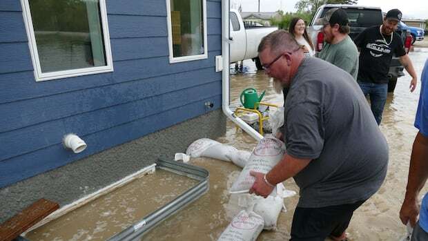 Southeastern Manitobans wade through flooded streets, basements after massive downpour