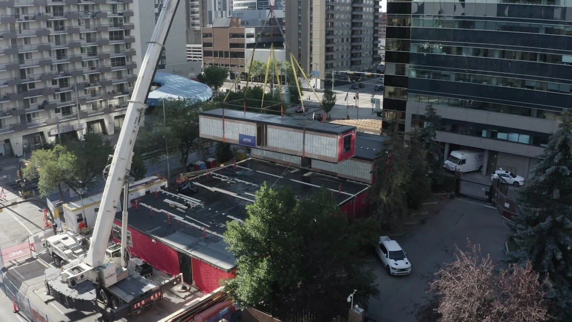 Piece by piece, cranes lift 84 prefabricated rentals into place in downtown Calgary