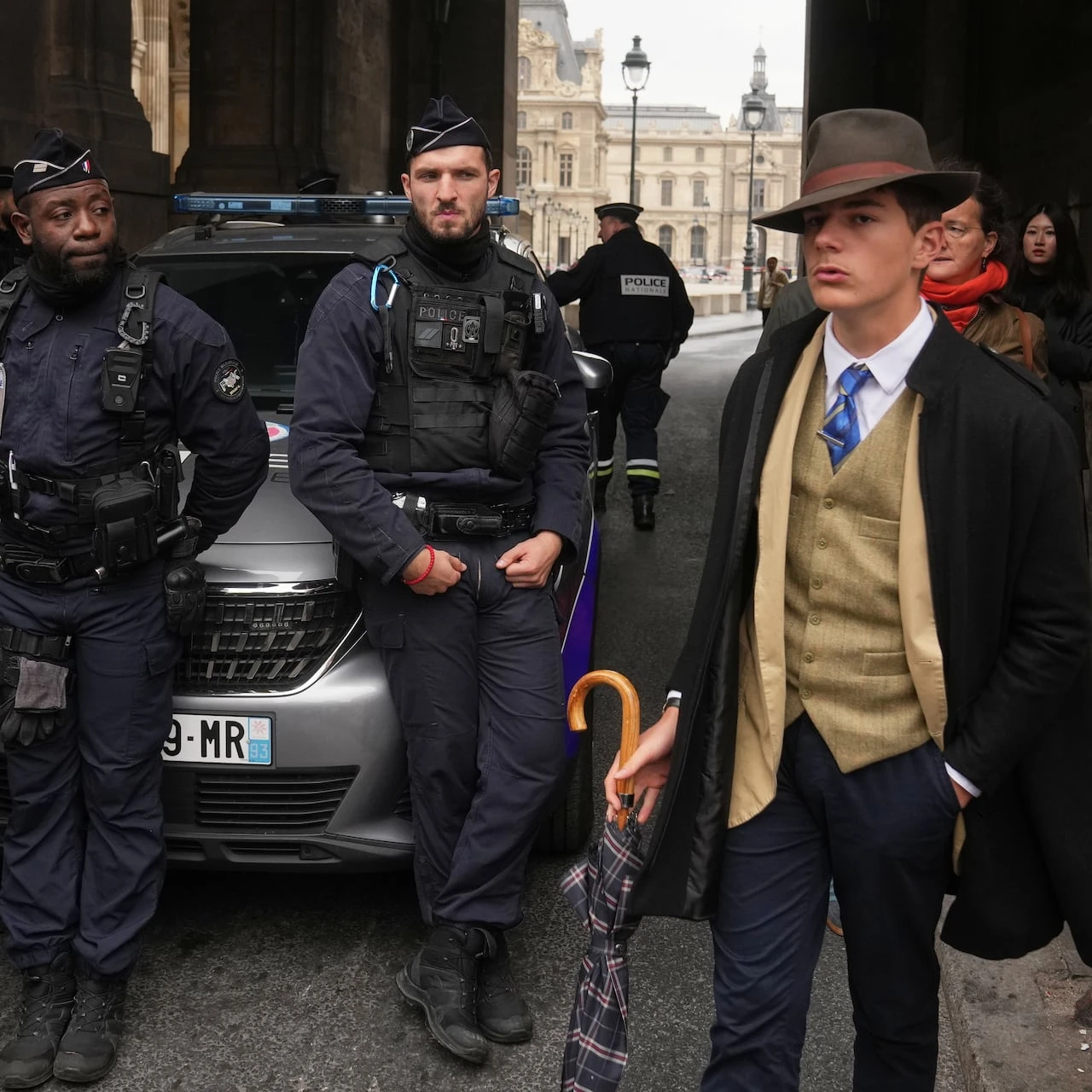 Turns out 'Fedora Man' in viral Louvre heist photo isn't AI — just a French teen with style