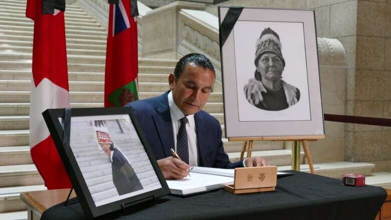 Dignitaries, public sign book of condolences for Cathy Merrick at Manitoba Legislature