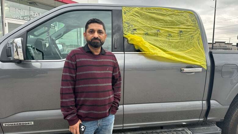 His truck was broken into while it sat at a London Ford dealership, but the dealer says it's not liable