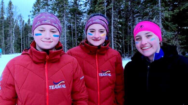 Now, that's friendly competition: 3 skiers at N.L. Winter Games link arms and finish together