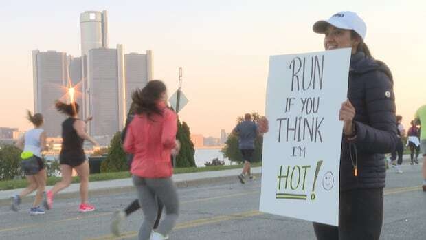 How funny signs and cheering supporters keep Detroit Marathon runners going