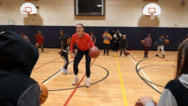 Students at a Thunder Bay public school shoot hoops with an Olympic basketball player