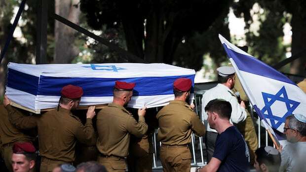 Israel buries soldiers killed in Lebanon, cleans up after Iran missile attack