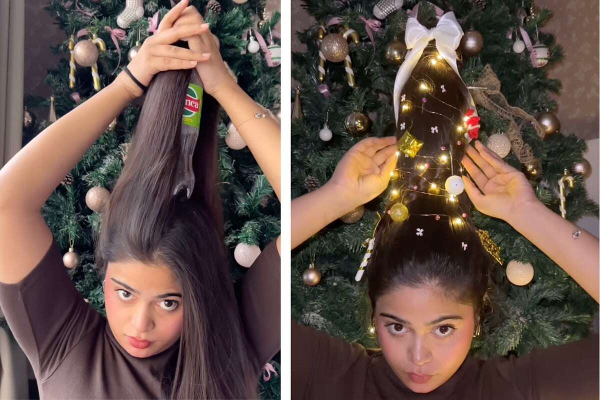 Steile Weihnacht! Frau setzt sich Tannenbaum auf den Kopf