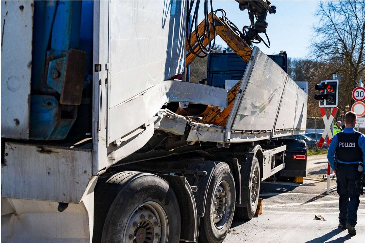 Lkw bei Wendemanöver an Bahnübergang von Schranken überrascht, dann kommt der Zug