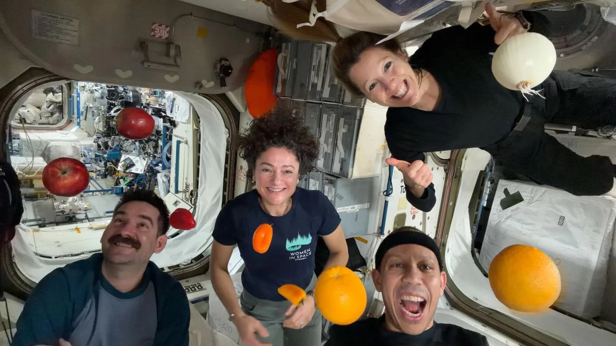 ISS astronauts pose with fresh fruit in microgravity