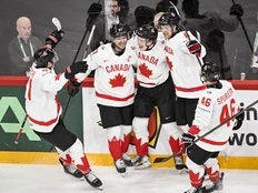 MacKinnon has three points, Canada finishes first in group with win over Sweden