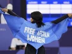 Olympian honours ‘forgotten’ Afghan women with cape made of a burqa