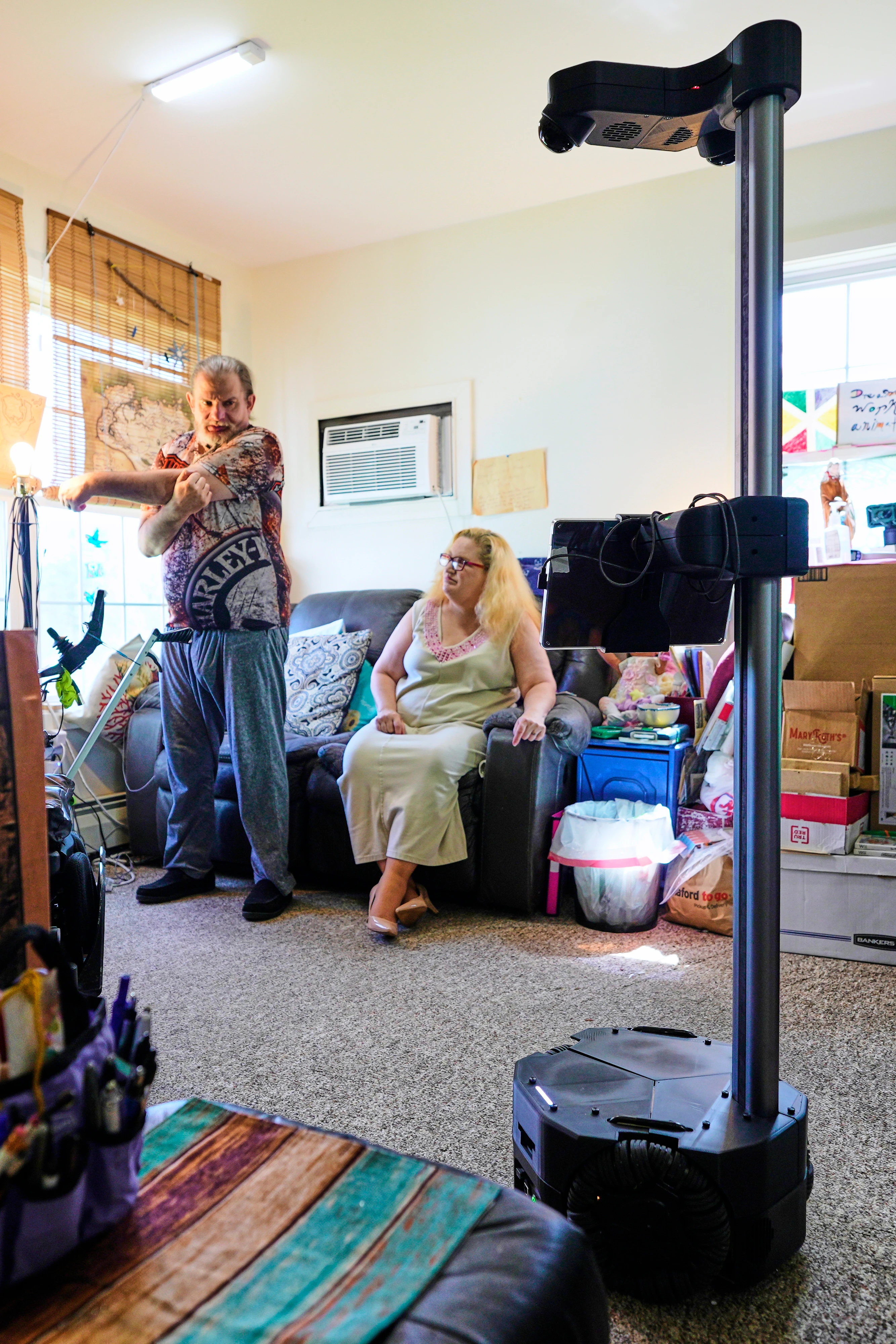 Caregiving robot helps ailing couple stay in their house. Could they replace nursing homes?