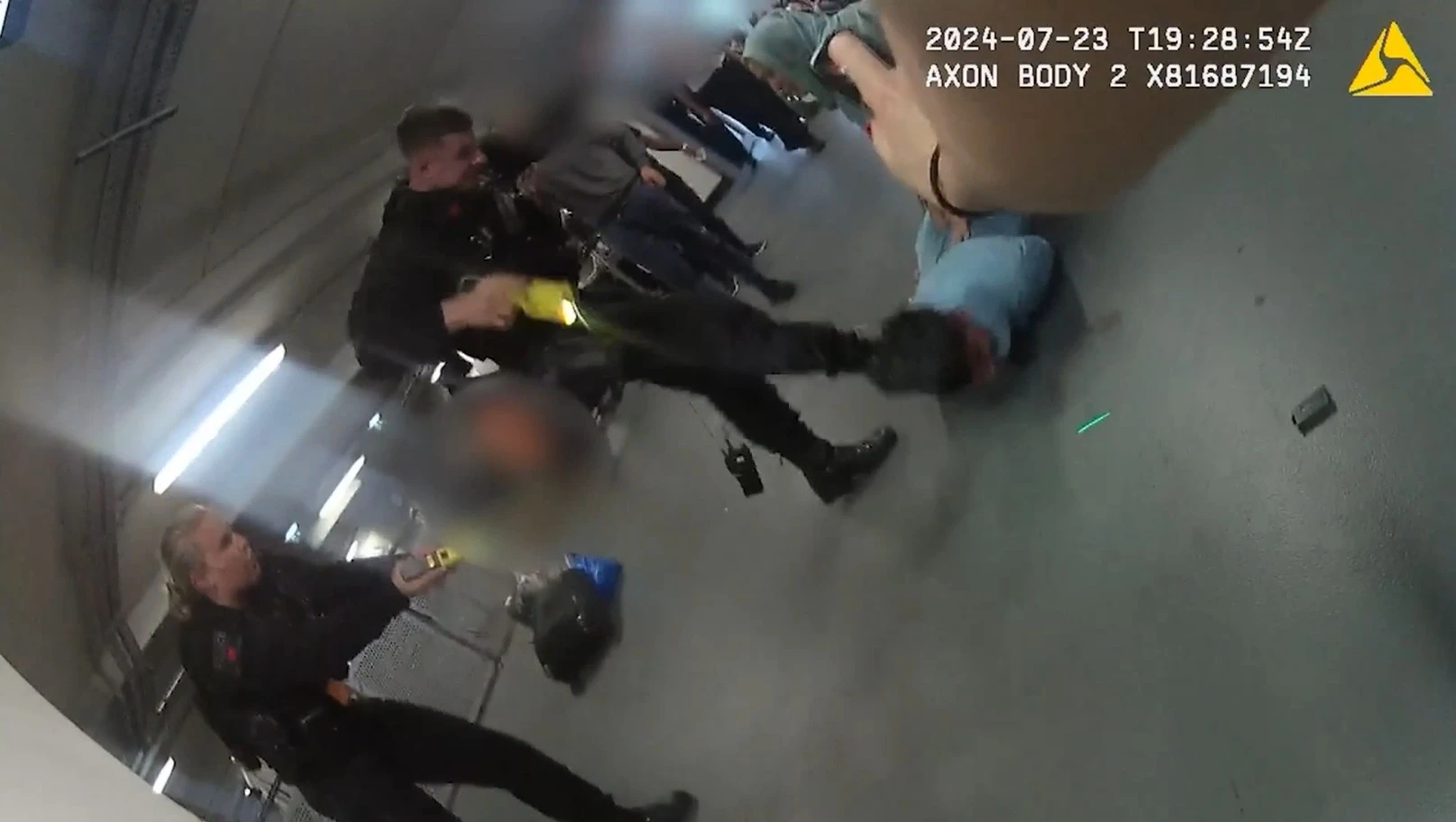 Cop who kicked man in head during airport brawl says he acted 'professionally'