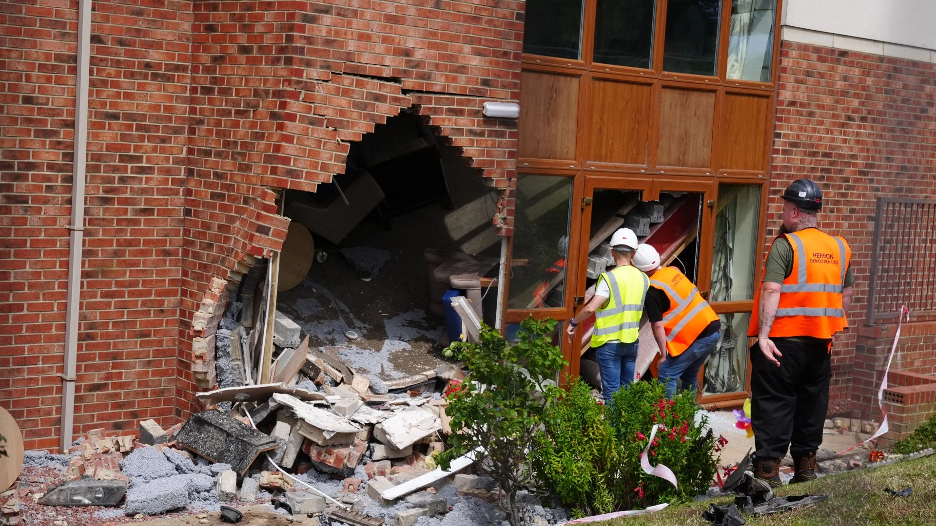 Two charged with kidnap and robbery after BMW crashes into care home