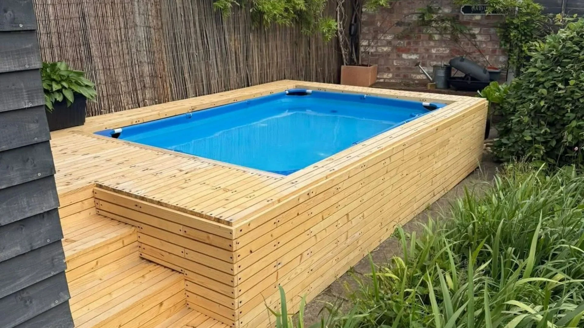 I made my own built-in outdoor pool using old palettes and a cheap paddling pool