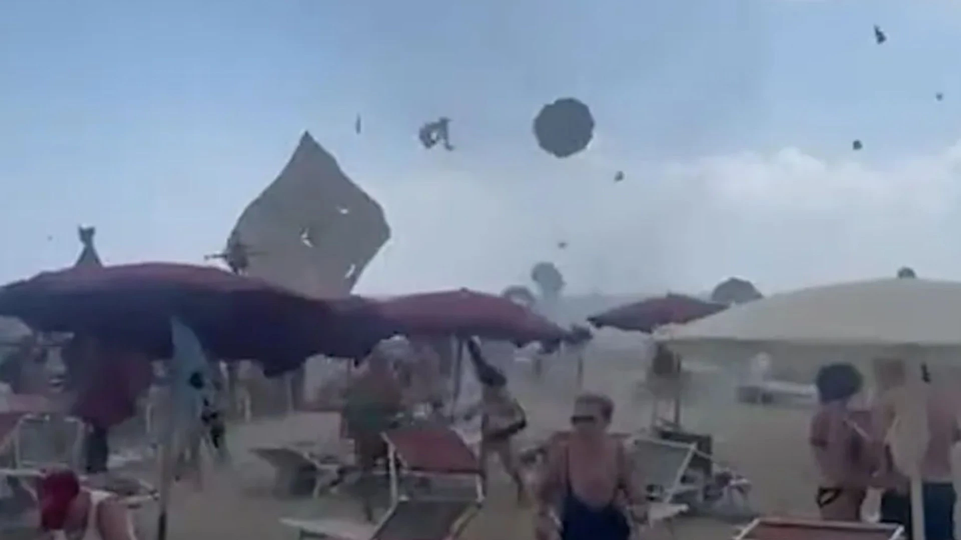 Moment tourists flee as TORNADO hits Italian beach sending parasols flying