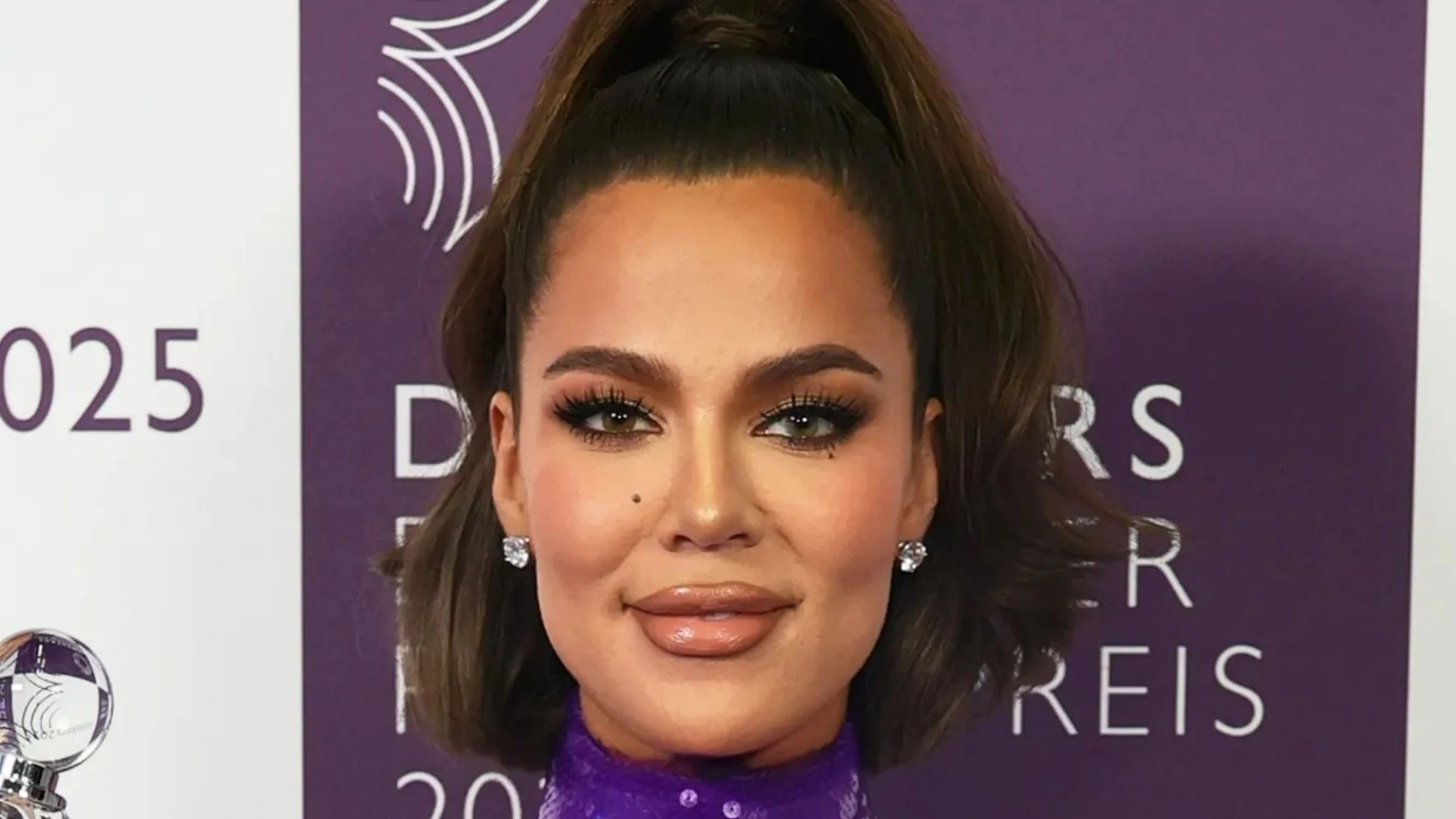 Khloe Kardashian looks incredible in skin tight purple dress at event in Germany
