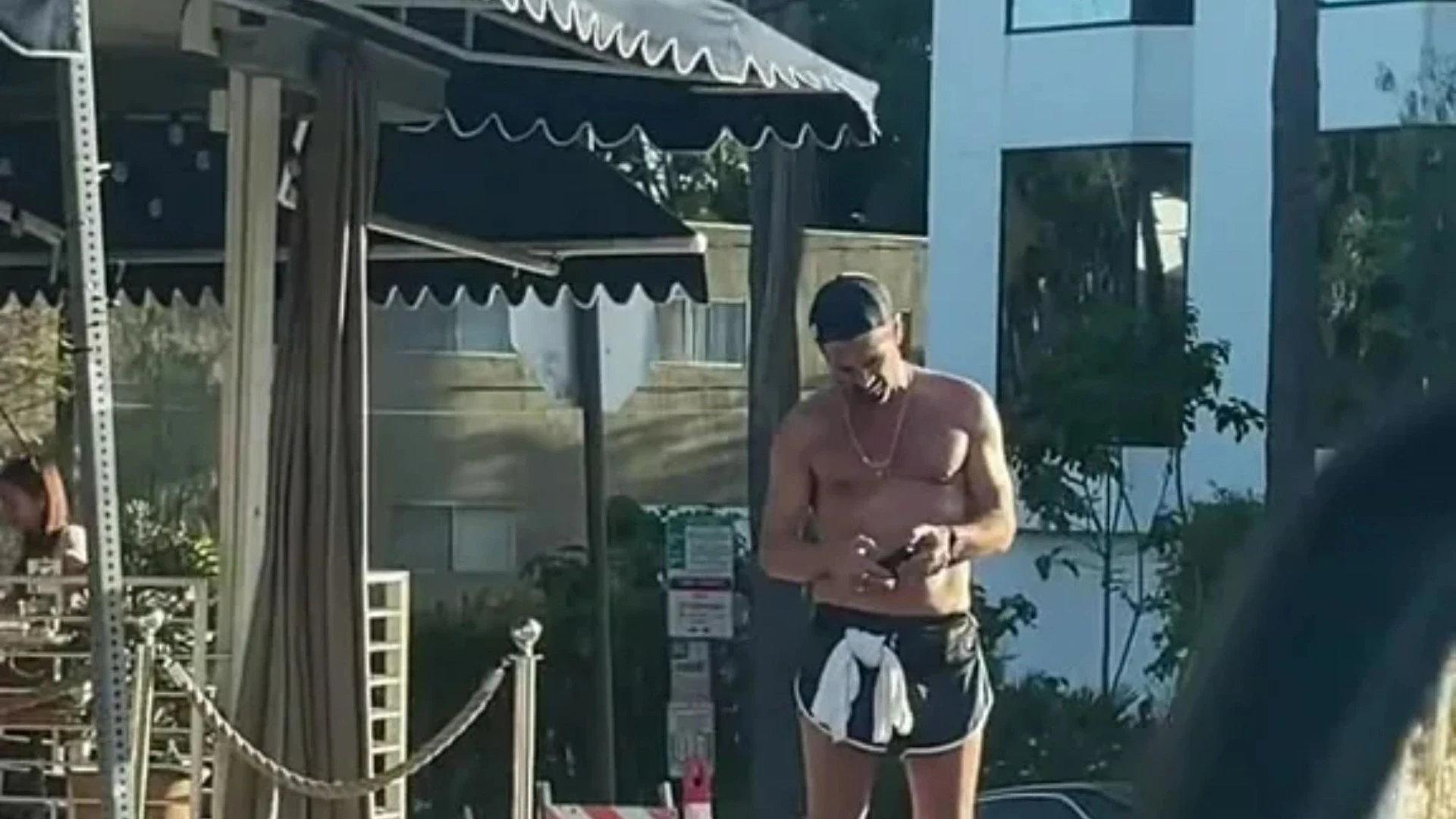 Fans shocked as they spot Hollywood star texting topless outside a coffee shop