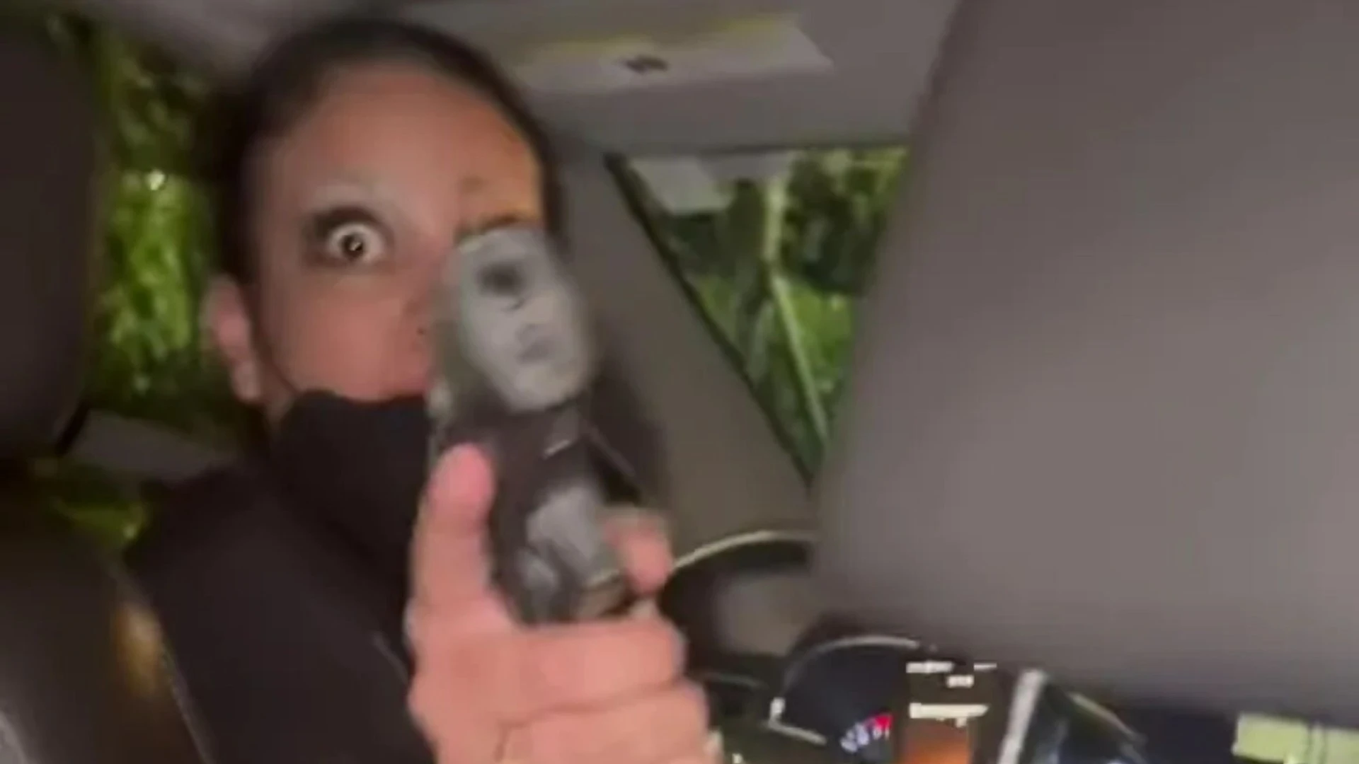 Terrifying moment raging Uber driver pulls GUN on female passenger