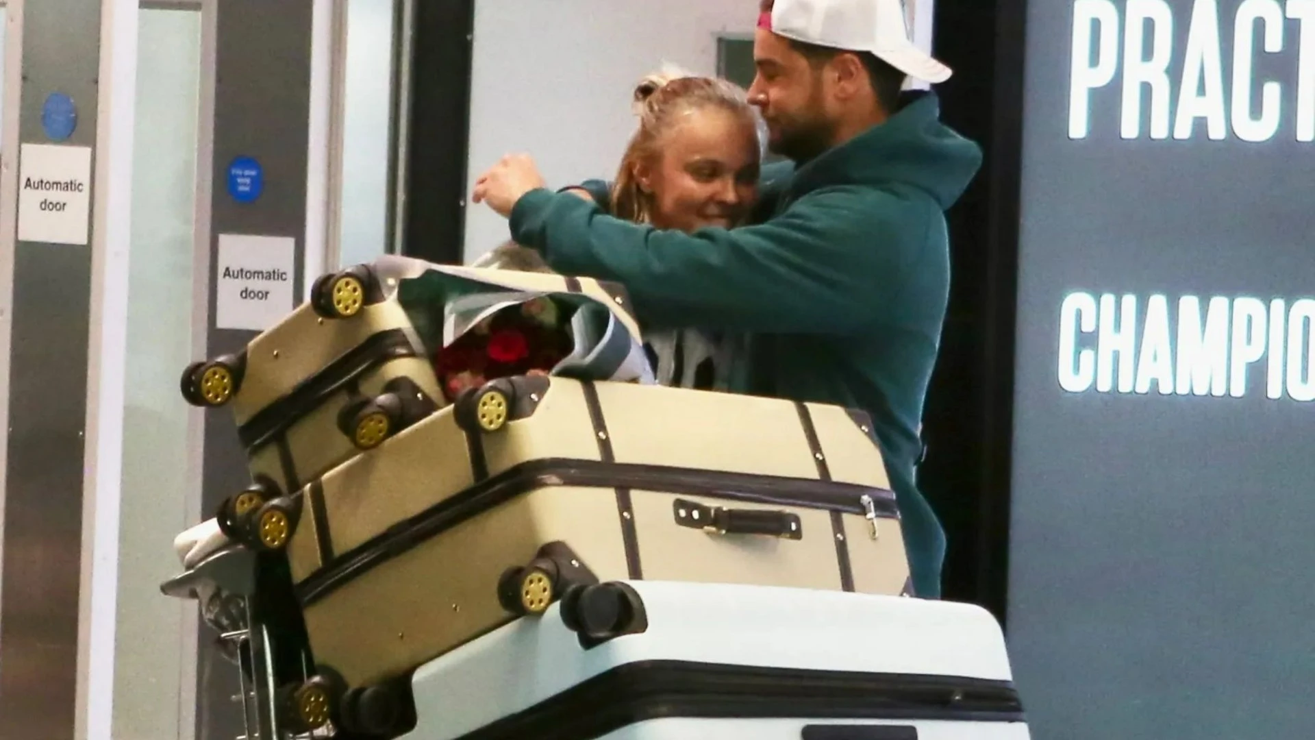 JoJo Siwa and Chris Hughes put on loved-up display as he meets her at airport