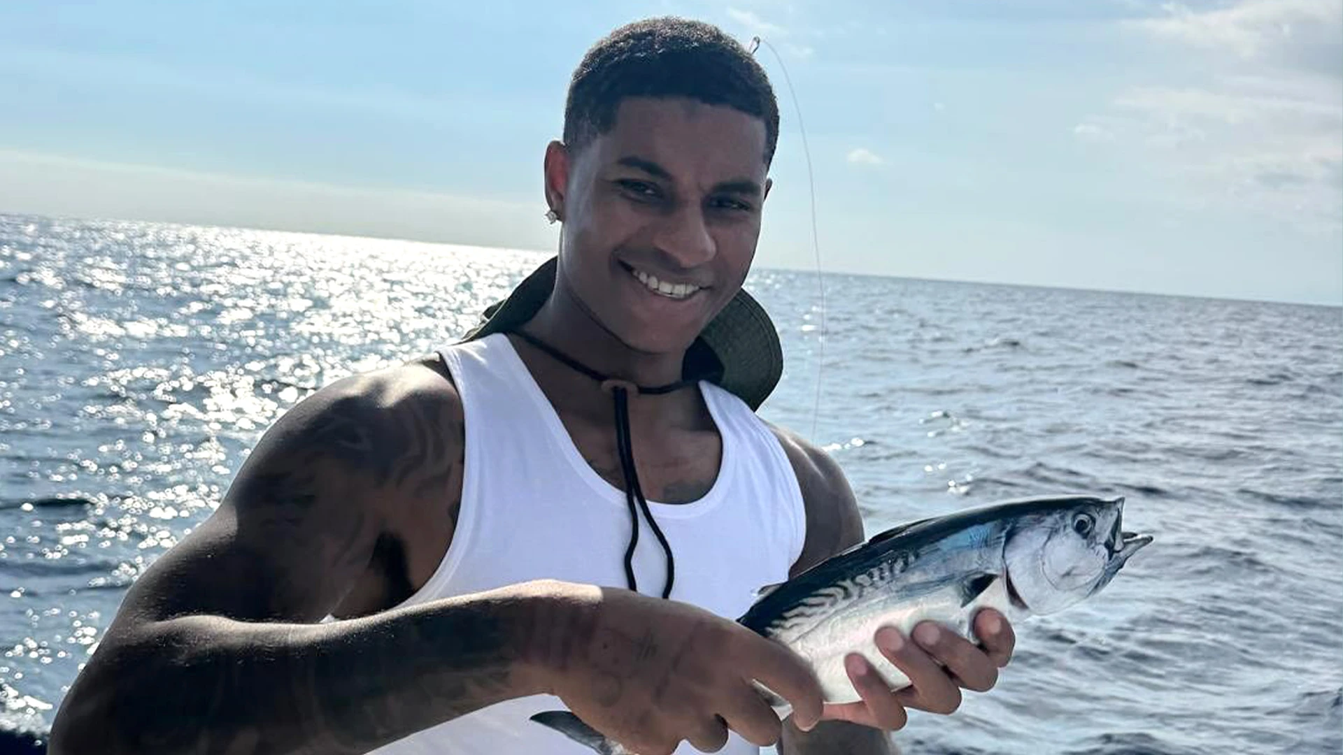 Rashford beams as he enjoys Barcelona downtime with a spot of fishing on yacht