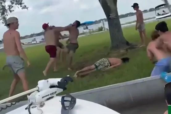 Moment man is knocked out in vicious brawl… before bikini-clad woman gives CPR