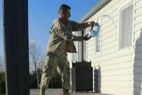 Shocking moment combat clad stalker pours ‘petrol’ outside woman's home
