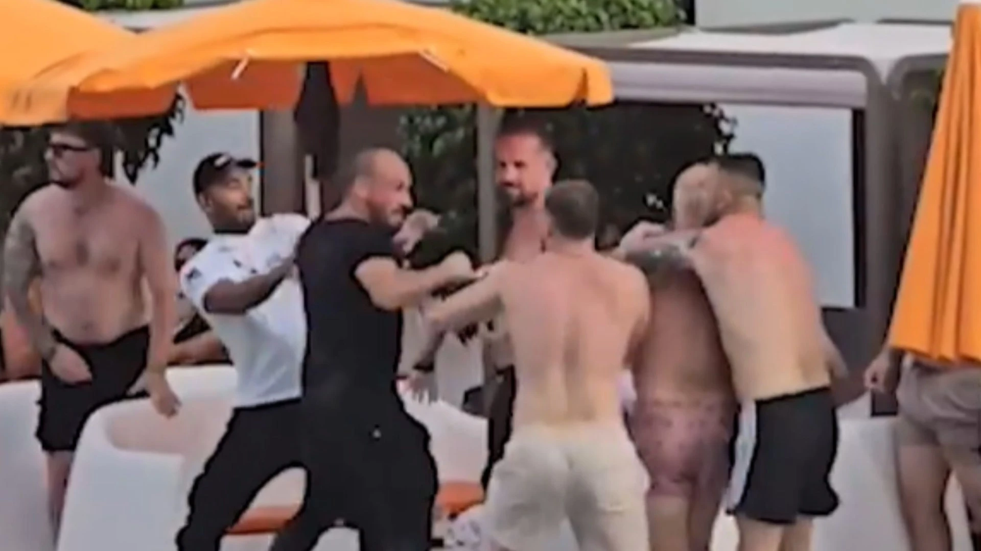 Moment fight breaks out at Benidorm pool with brawler tossed into water