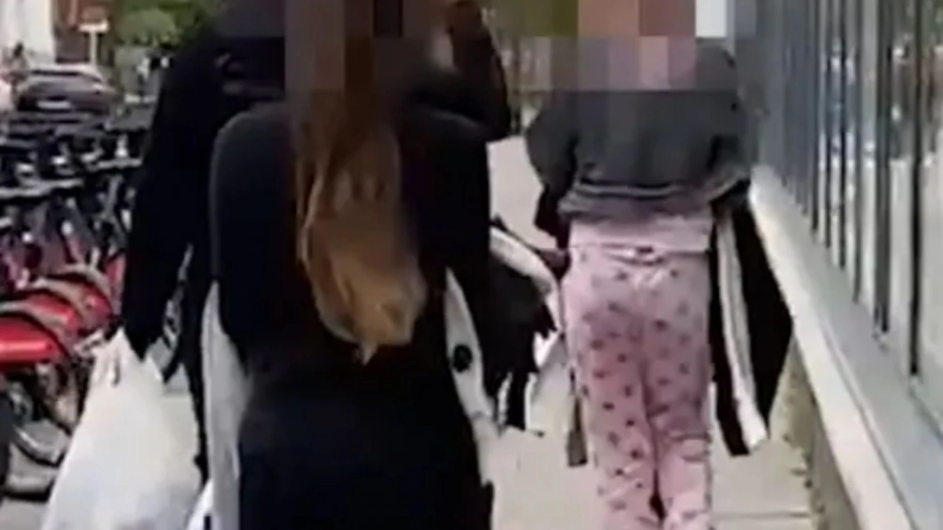 Moment pyjama-clad 'shoplifter' & her pals make off with £400 of H&M clothes