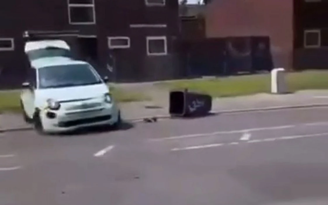 Moment Fiat 500 does DONUTS & speeds backwards as 60 masked youths spark chaos