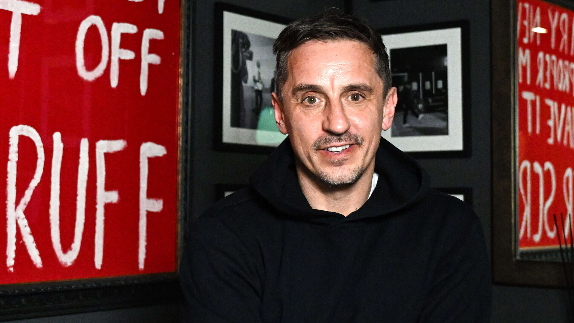 Inside Gary Neville HQ with framed Kop banner brutally insulting his appearance