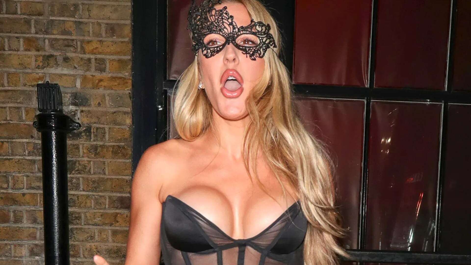 Braless Ellie Goulding almost bursts out of mesh corset dress at masked party