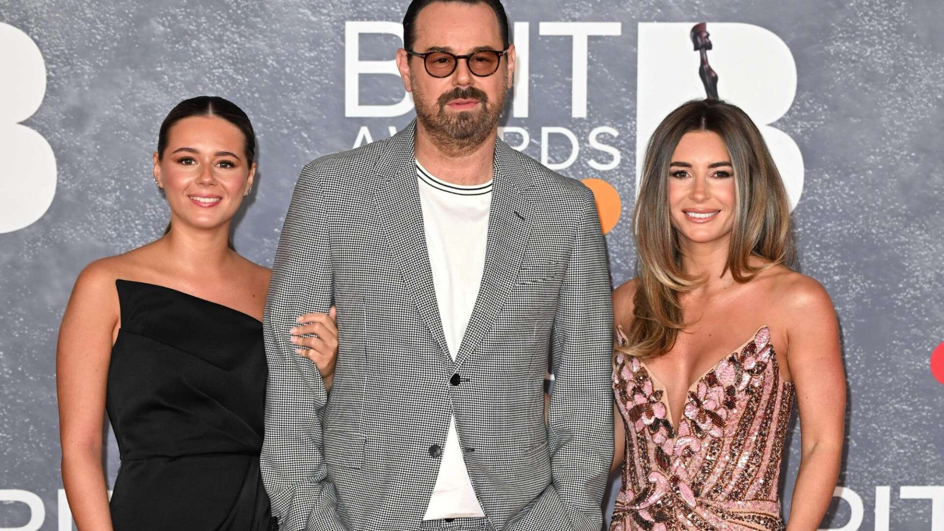 Danny Dyer poses with lookalike daughters Dani and Sunnie at the Brit Awards