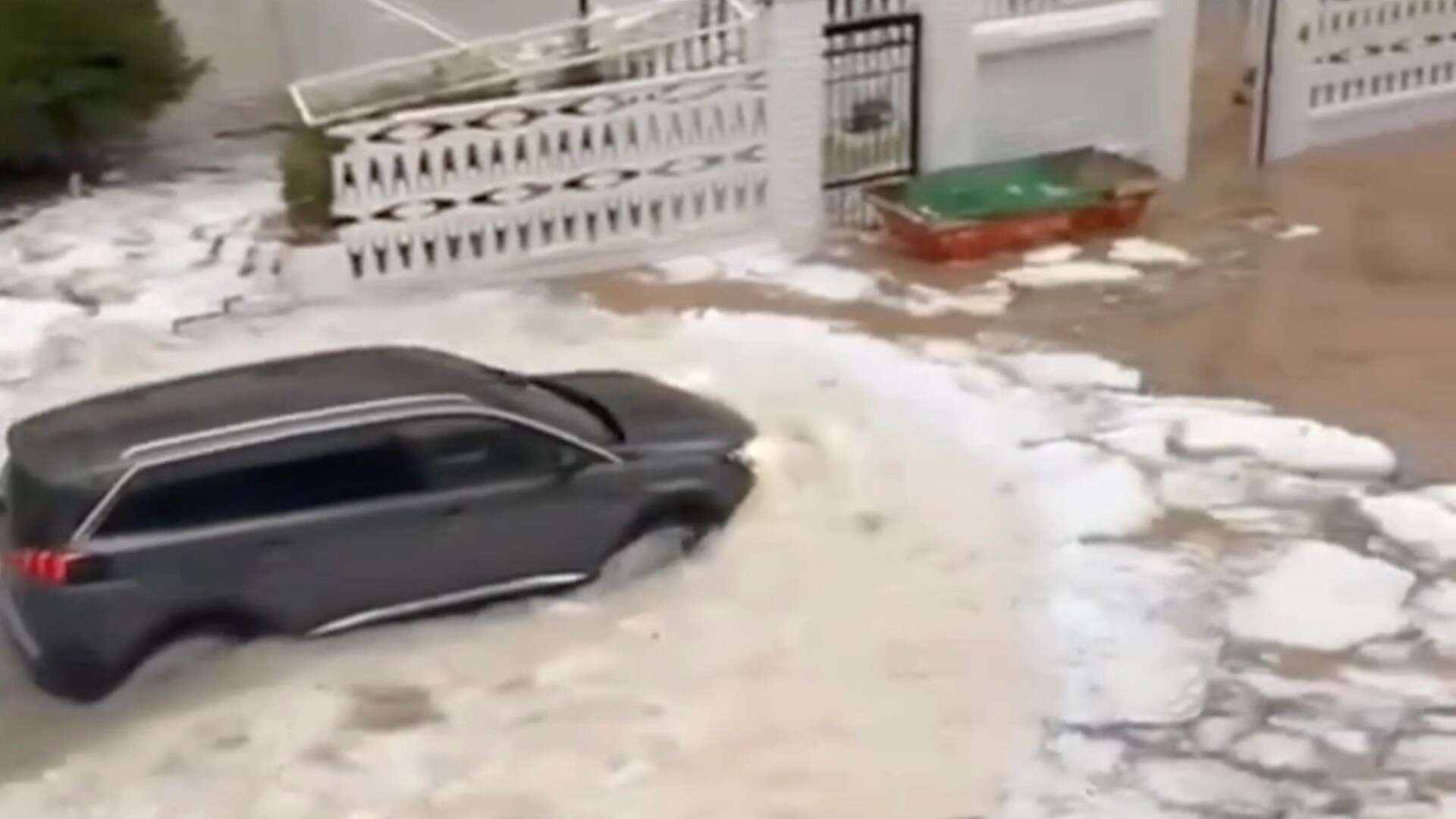 Moment hol hotspot is flooded by river of ICE as torrential rain batters Spain