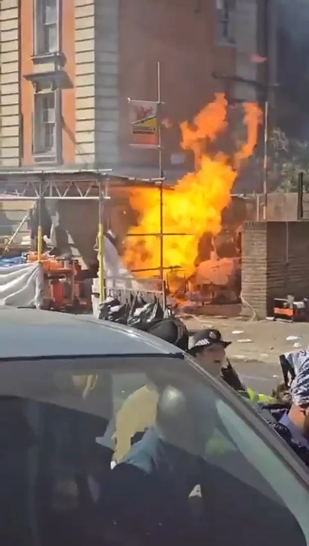 Moment fire rips through busy market stall as onlookers watch in horror