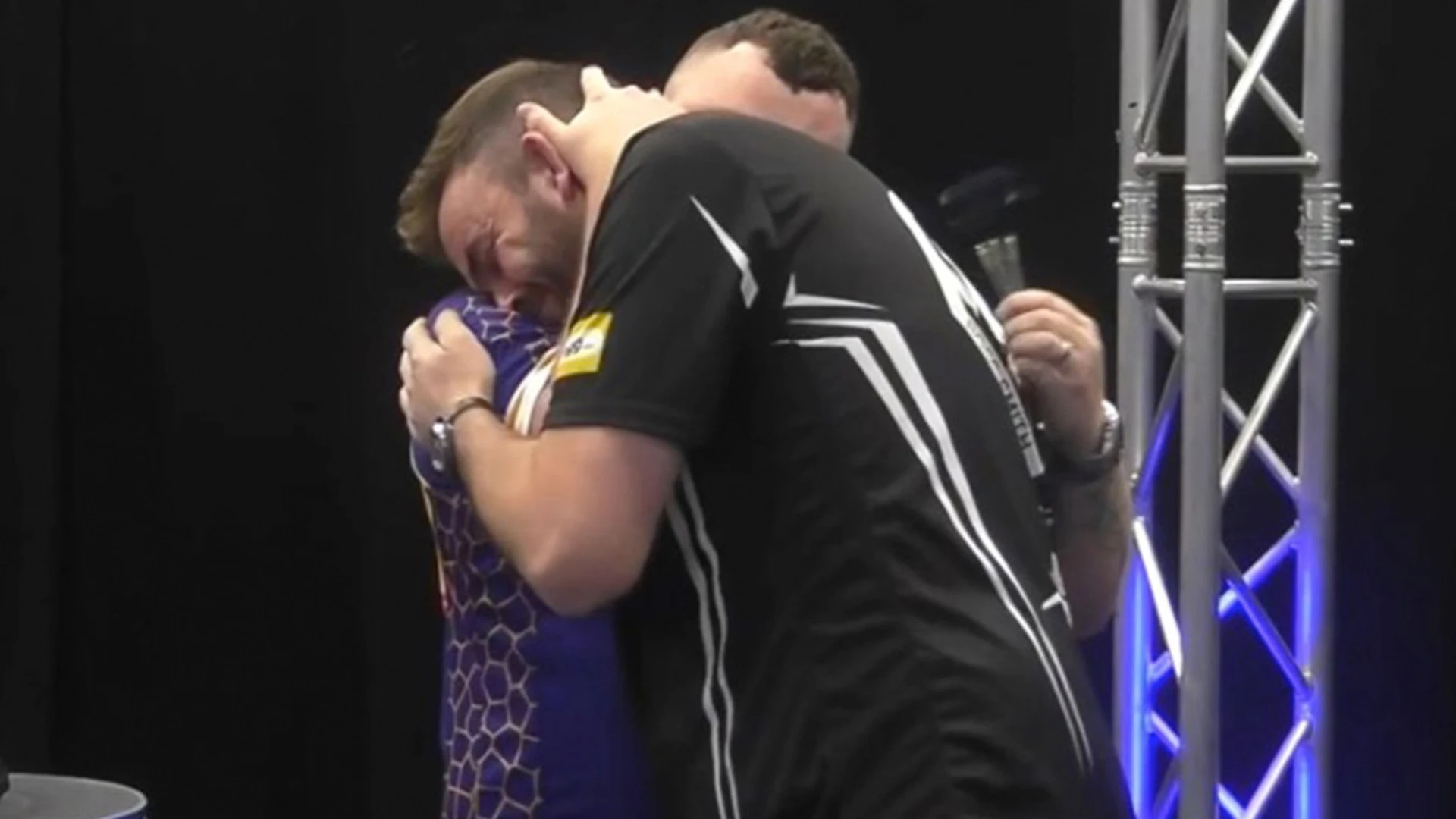 Darts star hugs rival after win days after family bereavement