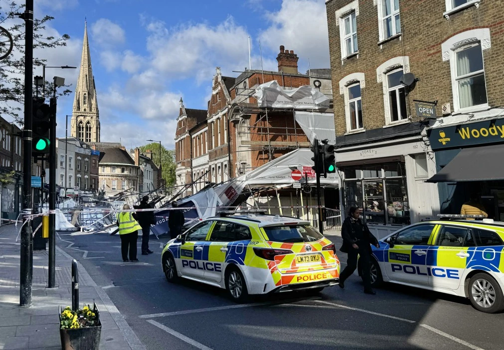 Scaffolding collapses onto busy UK high street 'trapping driver under rubble'